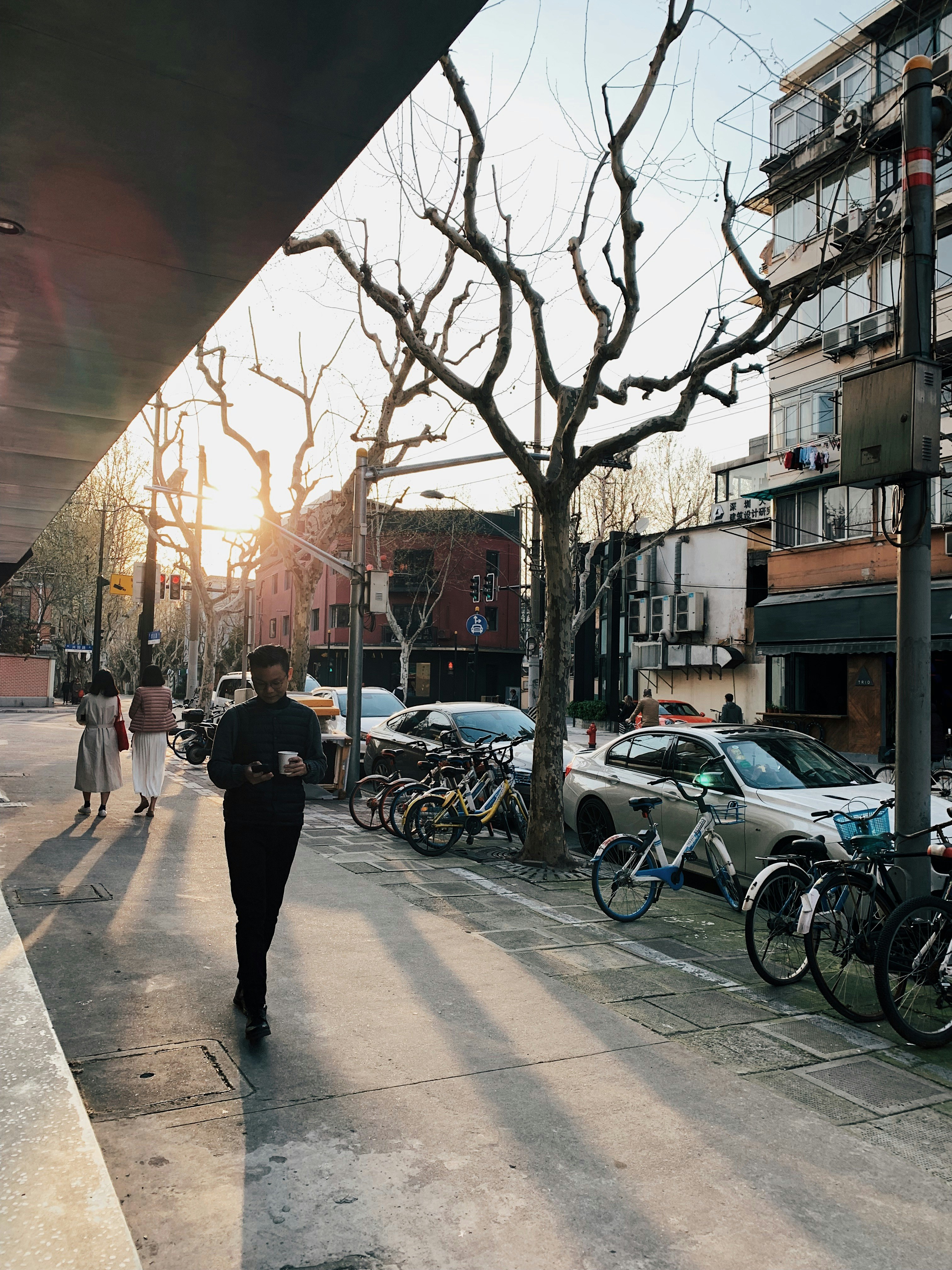 man in black top walking on pavement